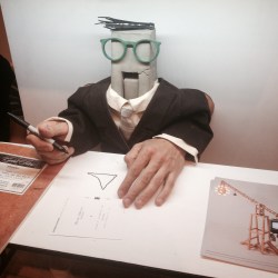 Kirley-Lyons holding the fort signing postcards for Steven